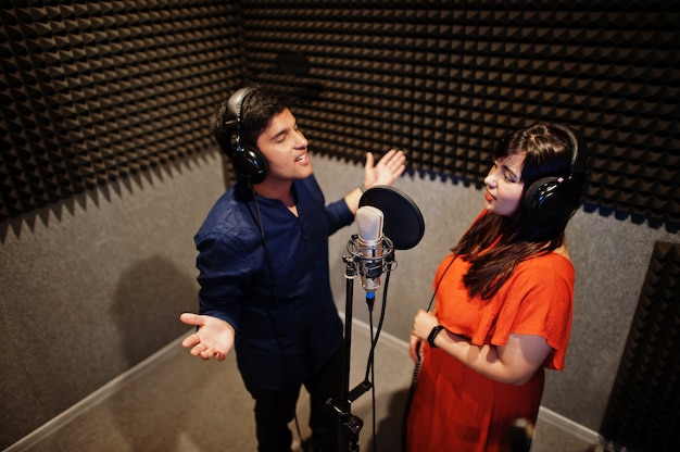 Voice coaching class showing microphone technique for aspiring singers and performers